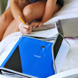 girl studying bed pencil writing notes holding binder blue school college branded UGC content